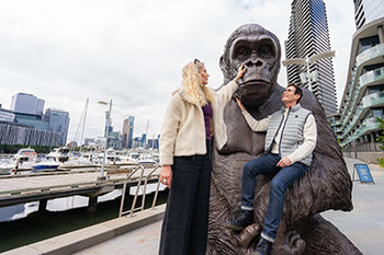 Photo of artists Gillie (left) and Marc (right) with their giant bronze sculpture of a gorilla.