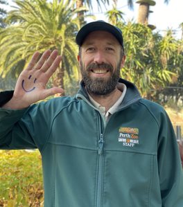 Male with smiley face drawn on hand